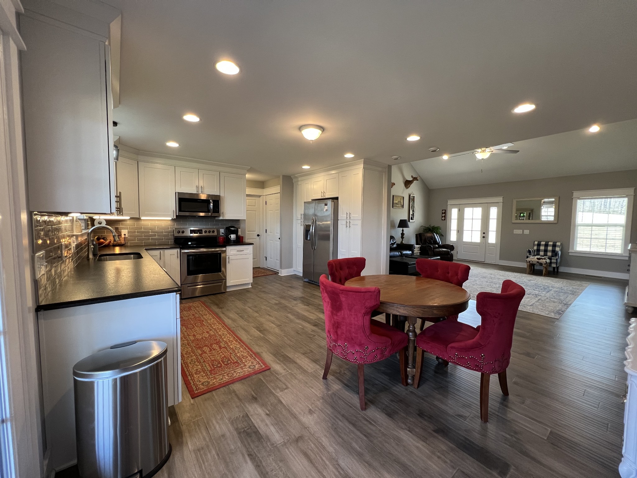 1951 Oak Grove Road Red Boiling Springs, TN 37150 - Photo 21 of 60 a kitchen with stainless steel appliances kitchen island granite countertop a dining table chairs refrigerator and sink