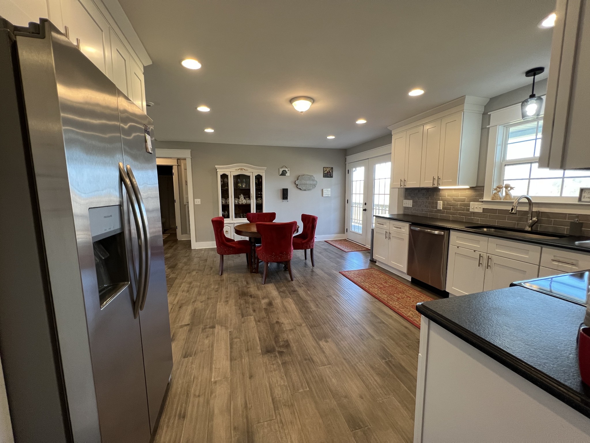 1951 Oak Grove Road Red Boiling Springs, TN 37150 - Photo 24 of 60 a kitchen with stainless steel appliances granite countertop sink stove refrigerator and wooden floor