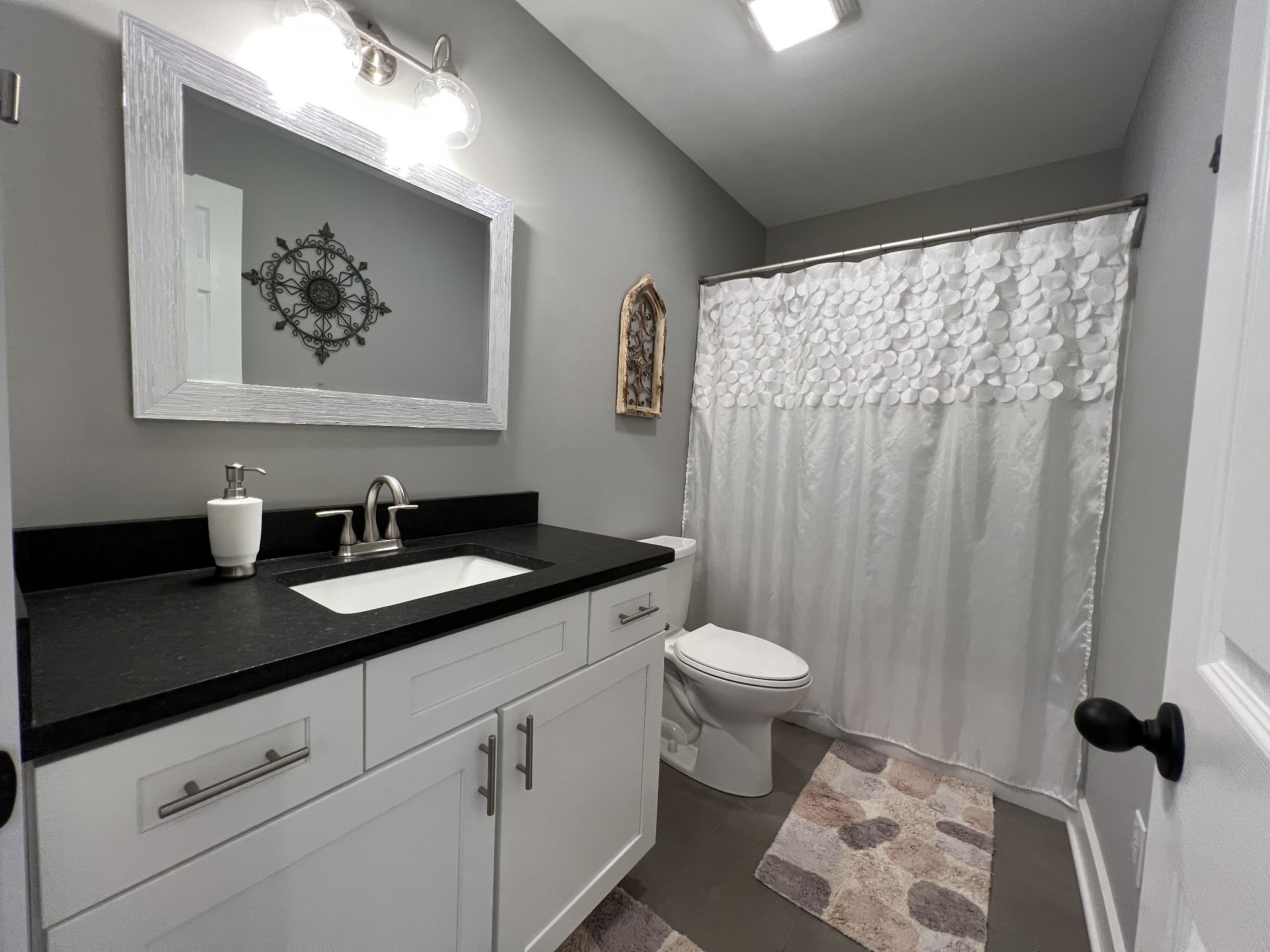 1951 Oak Grove Road Red Boiling Springs, TN 37150 - Photo 41 of 60 a bathroom with a granite countertop sink toilet and a mirror