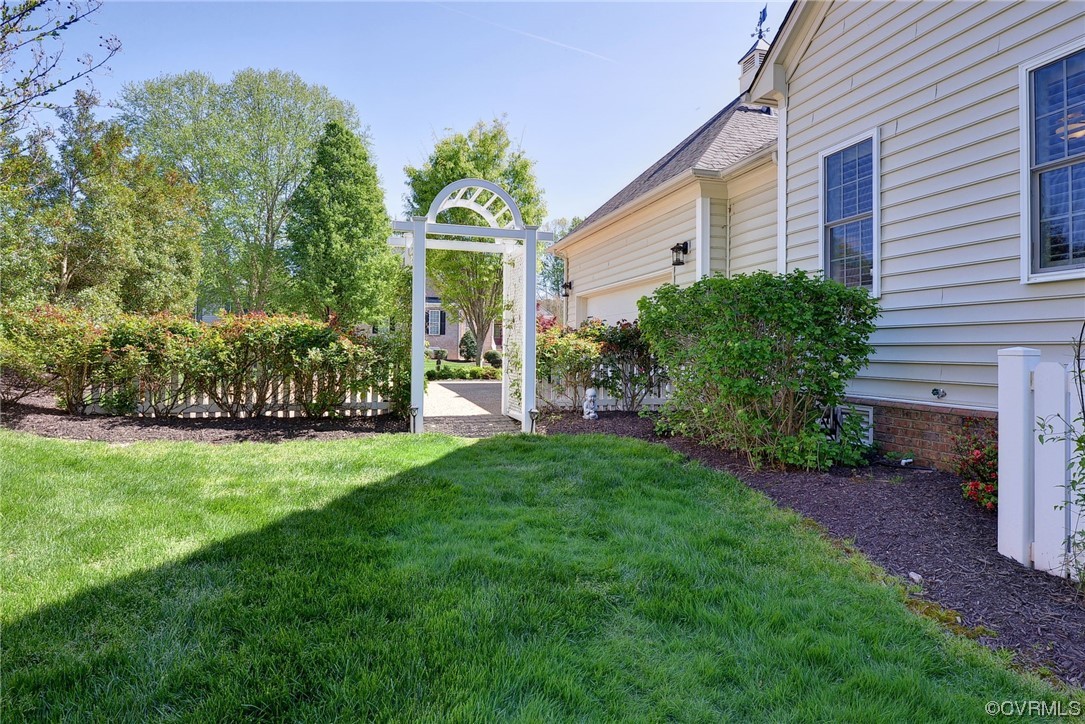 232 Beeston Fields Williamsburg, VA 23188 - Photo 33 of 39 a view of a house with backyard and a garden