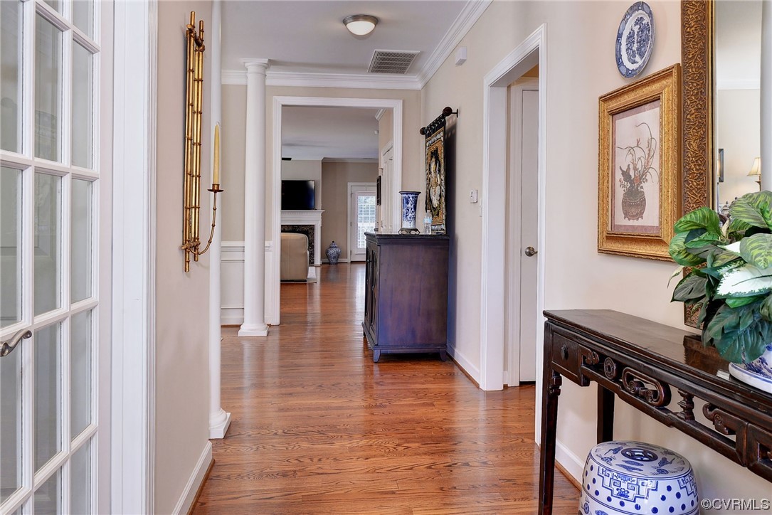 232 Beeston Fields Williamsburg, VA 23188 - Photo 5 of 39 a view of a hallway with wooden floor and a potted plant