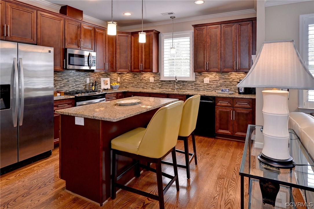 232 Beeston Fields Williamsburg, VA 23188 - Photo 8 of 39 a kitchen with stainless steel appliances granite countertop a stove a sink dishwasher a microwave oven and a refrigerator with wooden cabinets