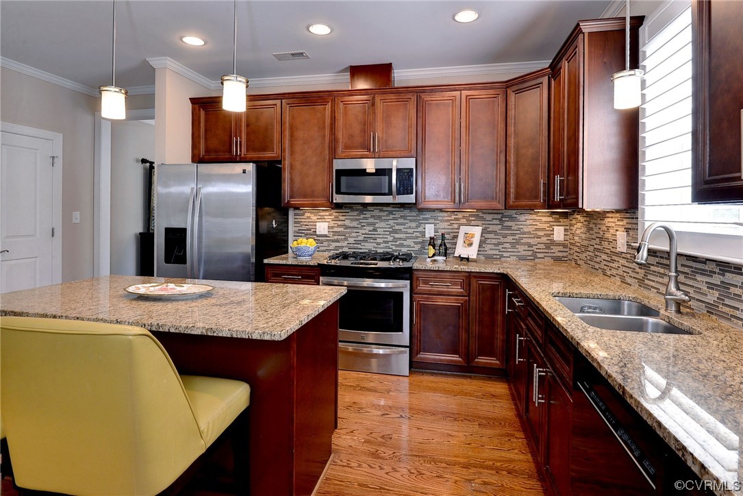 232 Beeston Fields Williamsburg, VA 23188 - Photo 10 of 39 a kitchen with kitchen island granite countertop wooden cabinets a sink a stove a refrigerator and a oven