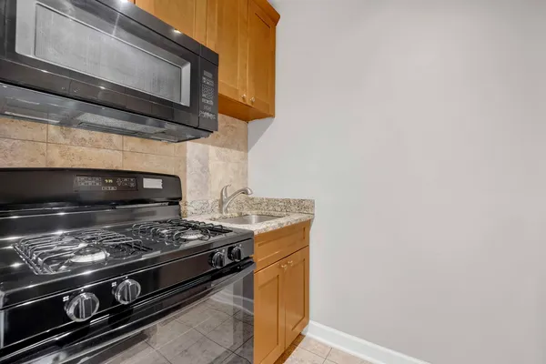 a stove top oven sitting inside of a kitchen
