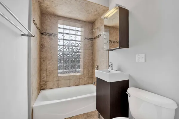 a bathroom with a sink toilet and shower