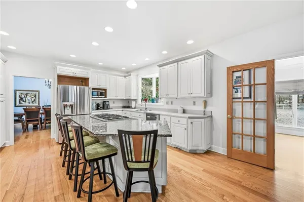a kitchen with a table chairs refrigerator and cabinets