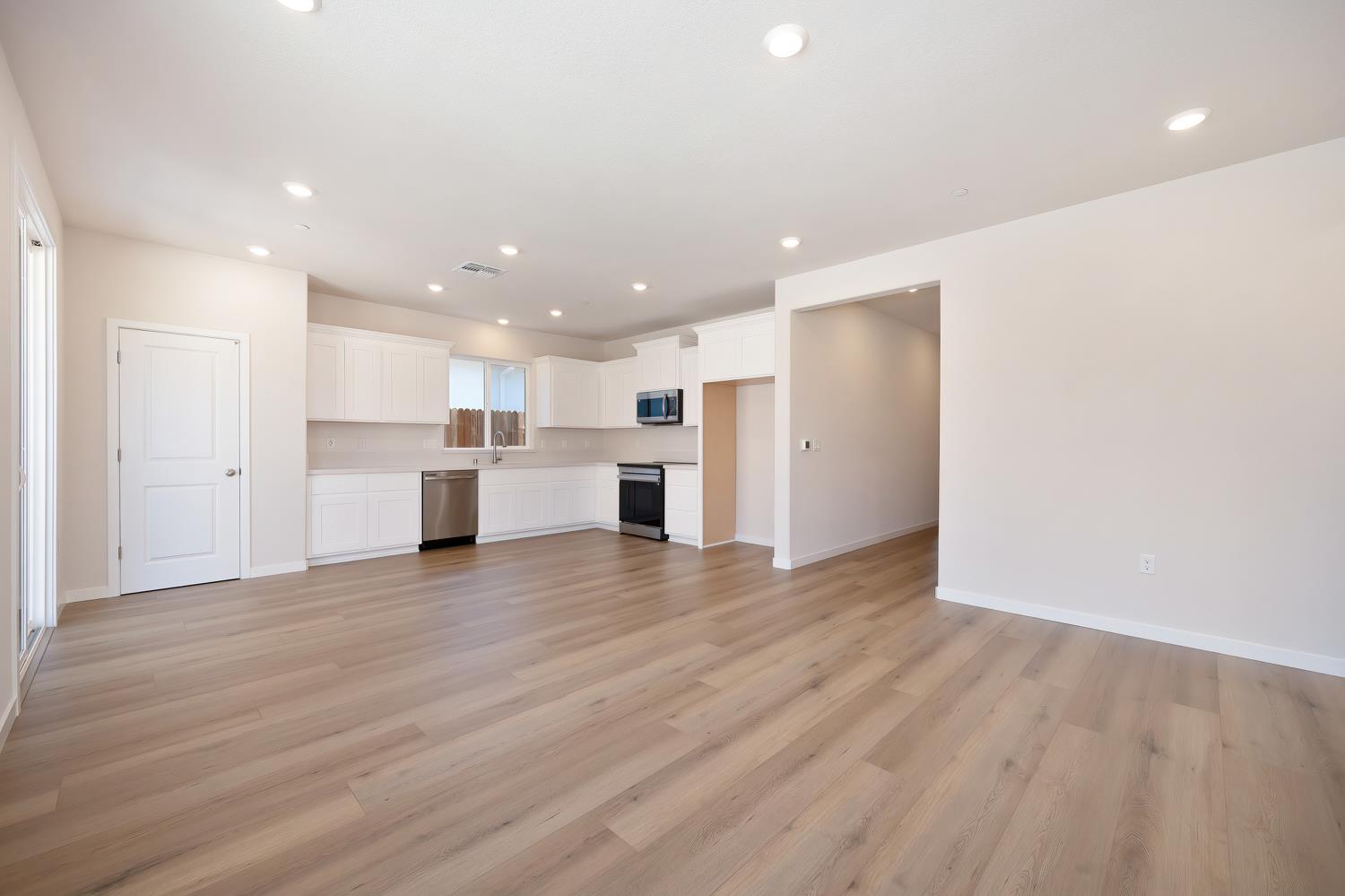 1089 Mallory Ridge Street Roseville, CA 95747 - Photo 11 of 36 a view of a kitchen with a refrigerator and a stove top oven