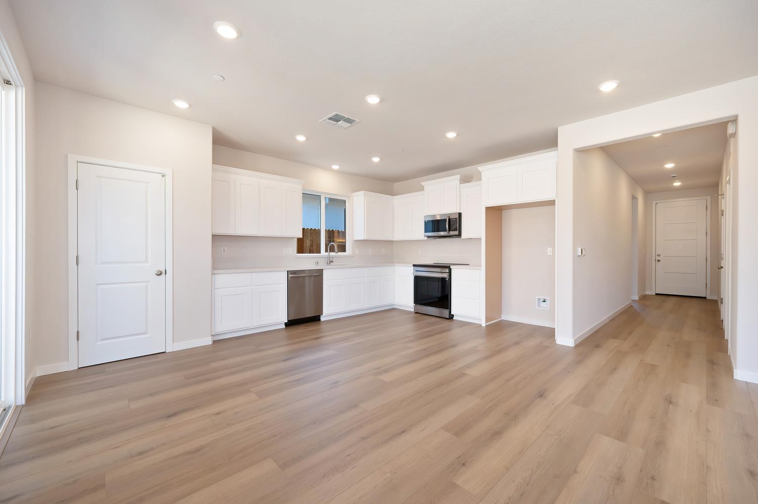1089 Mallory Ridge Street Roseville, CA 95747 - Photo 14 of 36 a view of a kitchen with wooden floor and electronic appliances