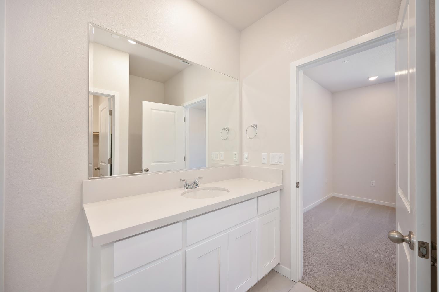 1089 Mallory Ridge Street Roseville, CA 95747 - Photo 20 of 36 a bathroom with a sink and a mirror
