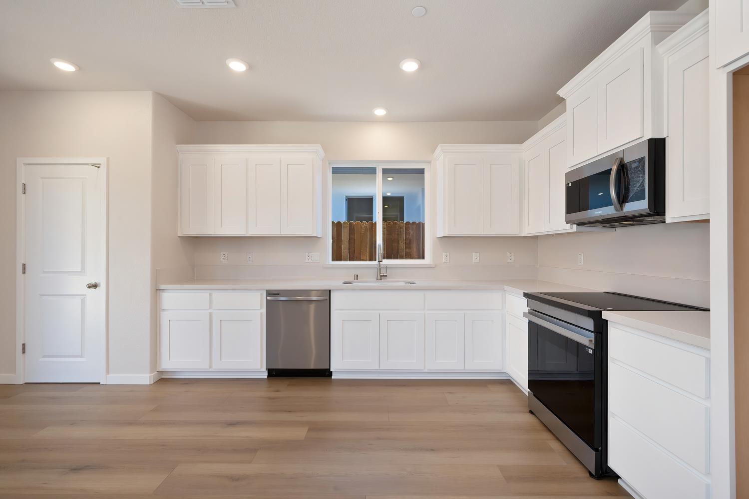 1089 Mallory Ridge Street Roseville, CA 95747 - Photo 5 of 36 a kitchen with a sink microwave and cabinets