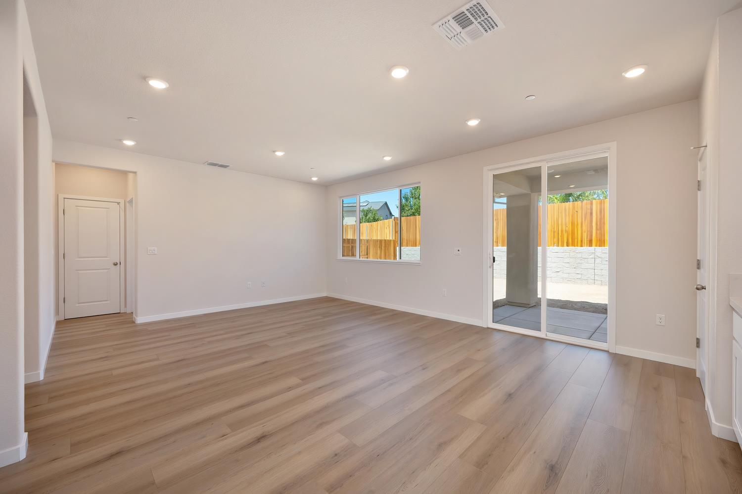 1089 Mallory Ridge Street Roseville, CA 95747 - Photo 7 of 36 an empty room with wooden floor and windows