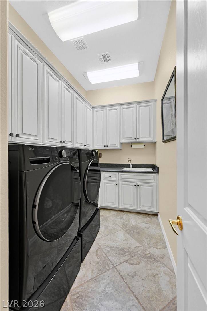 1823 Baton Rouge Street Henderson, NV 89052 - Photo 28 of 60 Ample built-in cabinetry and durable tile flooring define this highly functional utility space.