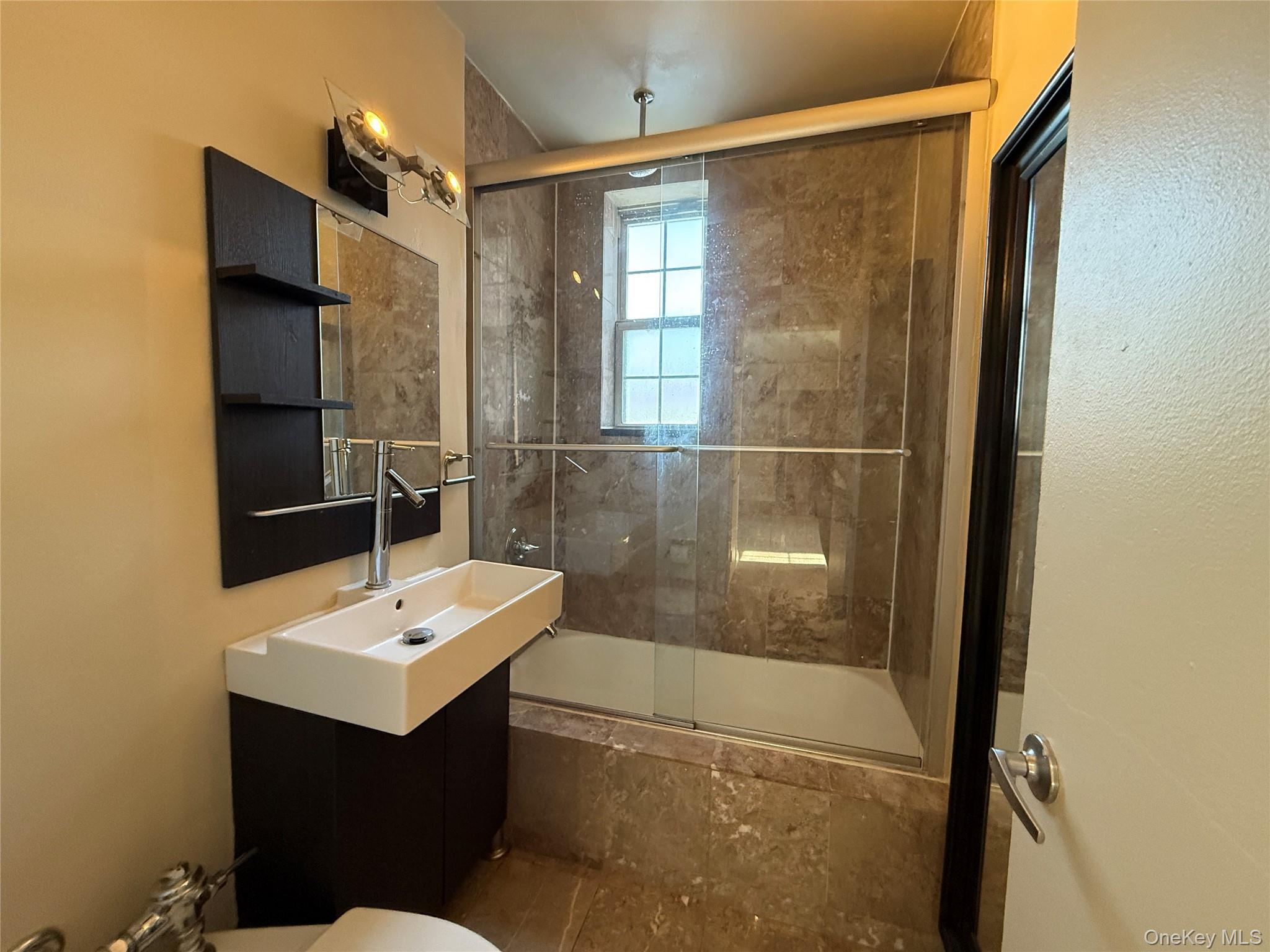 796 Bronx River Road, Unit B38 Bronxville, NY 10708 - Photo 11 of 31 a bathroom with a sink mirror and shower