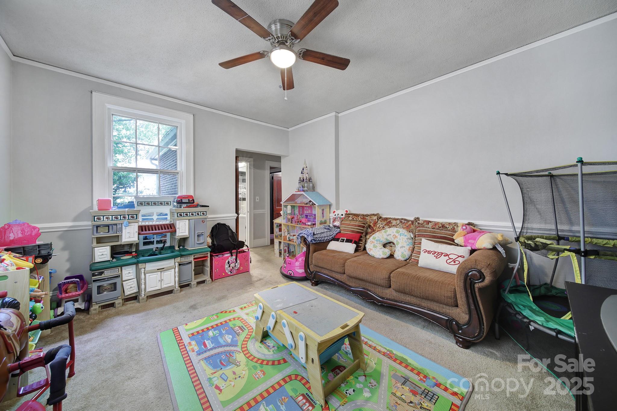 504 Chesterfield Avenue Lancaster, SC 29720 - Photo 12 of 24 a bedroom with furniture and a baby crib