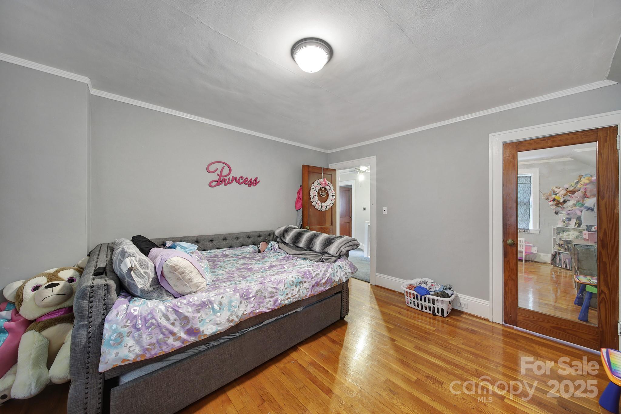 504 Chesterfield Avenue Lancaster, SC 29720 - Photo 19 of 24 a bedroom with bed and wooden floor