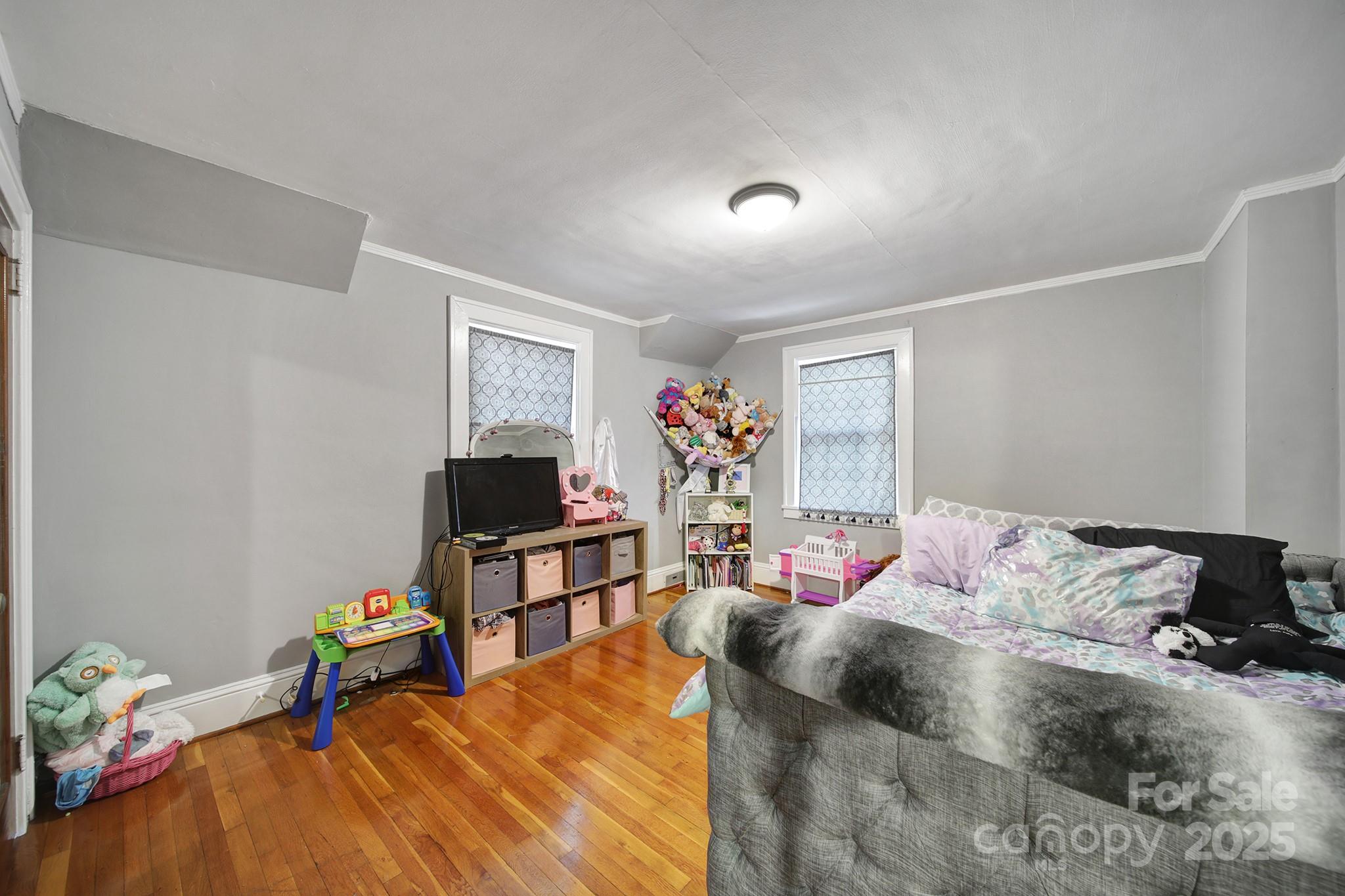 504 Chesterfield Avenue Lancaster, SC 29720 - Photo 20 of 24 a bedroom with a bed and wooden floor