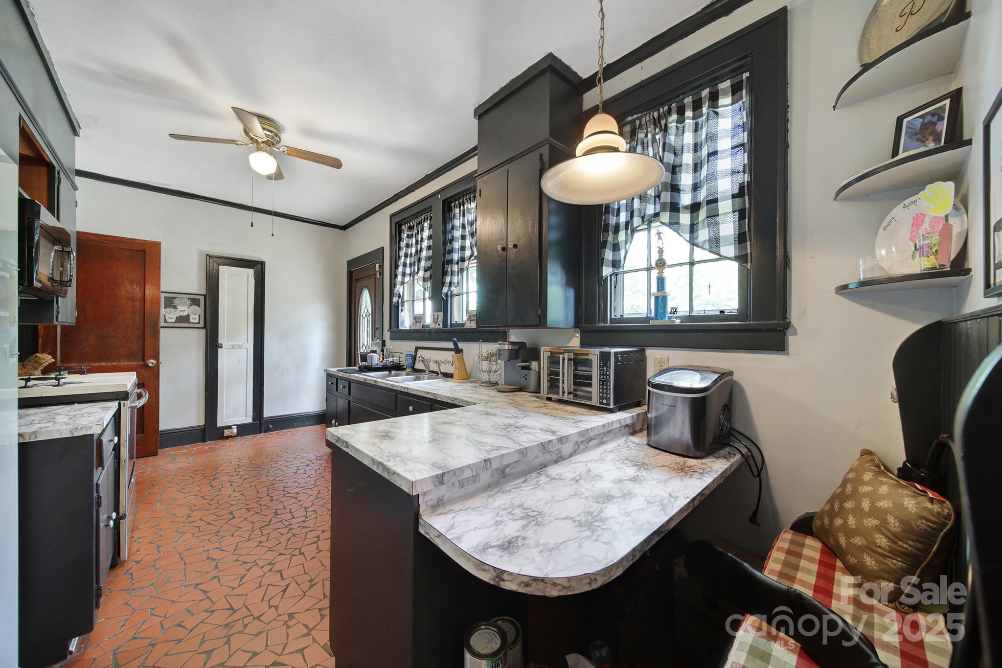 504 Chesterfield Avenue Lancaster, SC 29720 - Photo 8 of 24 a bathroom with a granite countertop sink a toilet and mirror