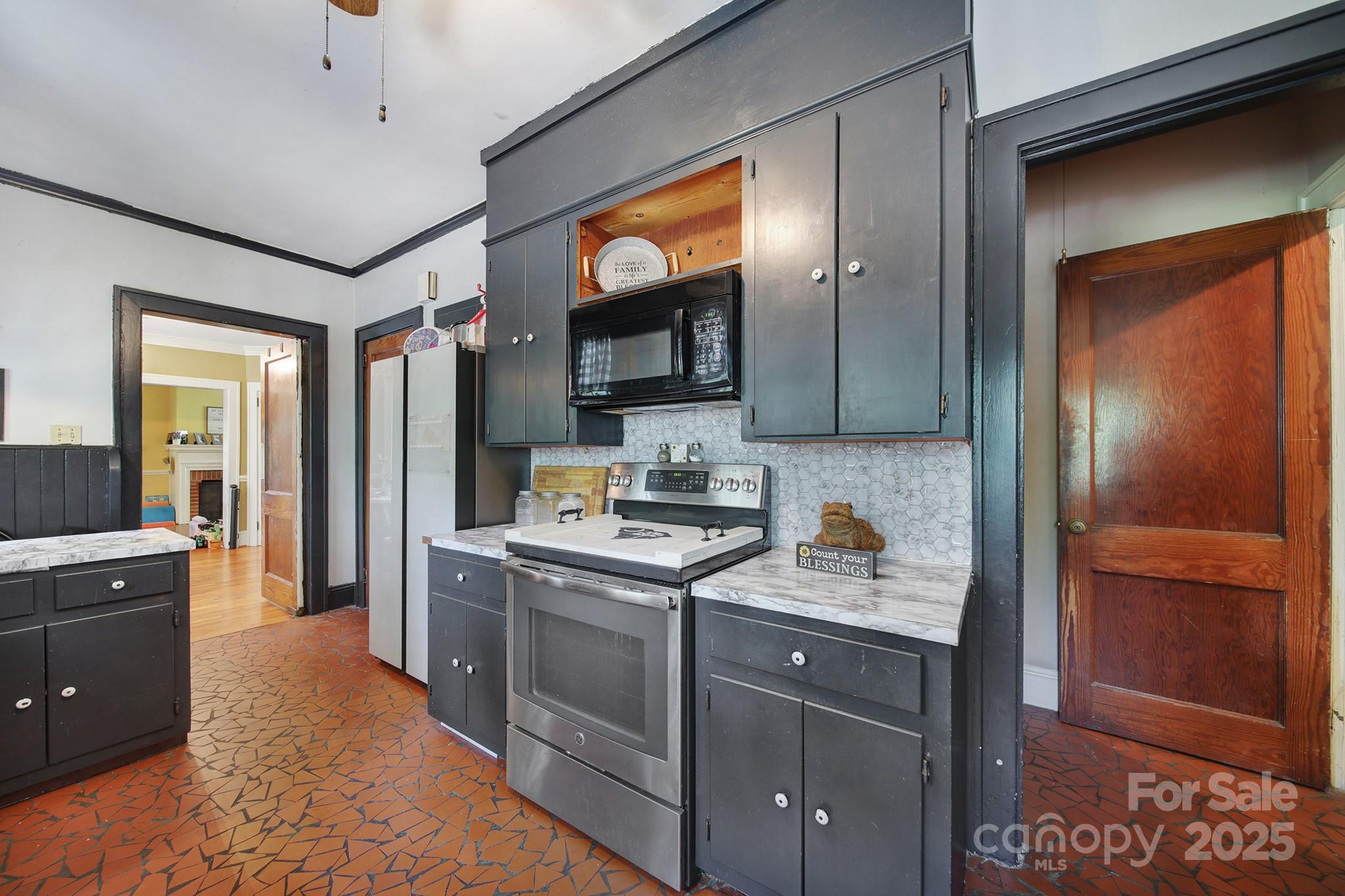 504 Chesterfield Avenue Lancaster, SC 29720 - Photo 9 of 24 a kitchen with a stove and a refrigerator