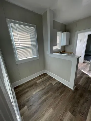 a view of kitchen with wooden floor and electronic appliances