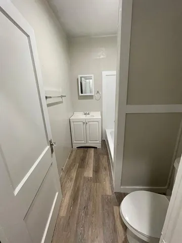 a bathroom with a sink a toilet a tub and shower