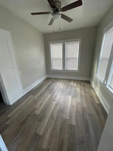 wooden floor in an empty room with a window