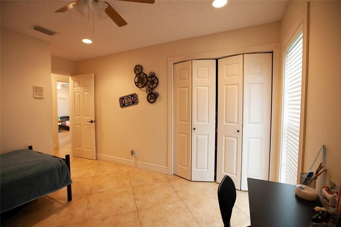 21836 Reflection Lane Boca Raton, FL 33428 - Photo 26 of 58 a bedroom with a bed and a window