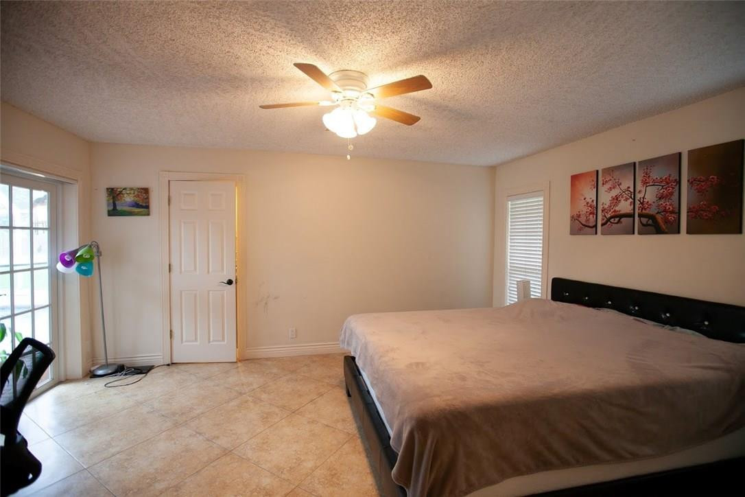 21836 Reflection Lane Boca Raton, FL 33428 - Photo 33 of 58 a bedroom with a bed and a chandelier