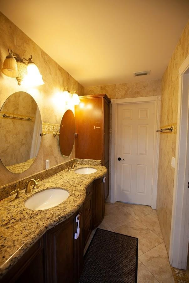 21836 Reflection Lane Boca Raton, FL 33428 - Photo 38 of 58 a bathroom with a granite countertop sink and a mirror