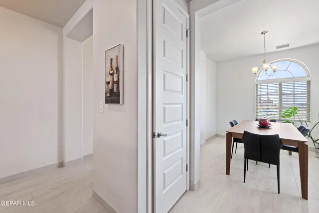 a view of a dining room with furniture and a chandelier