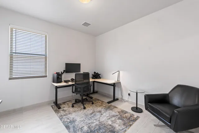 a work room with furniture and a window