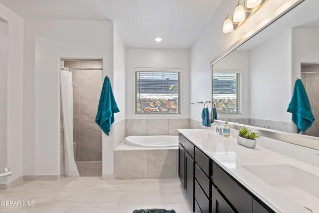 a bathroom with a bathtub a sink and a window