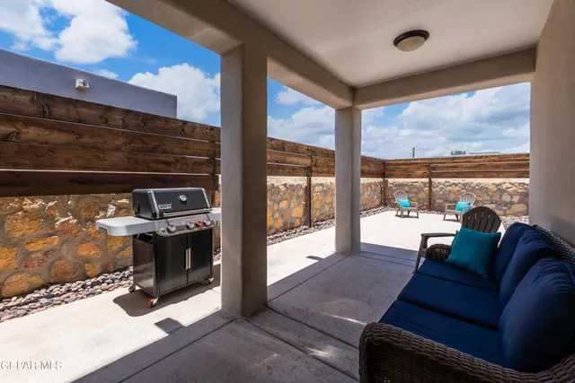 a living room with furniture a rug and a large window