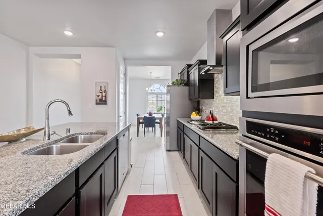 a kitchen with sink cabinets and stove