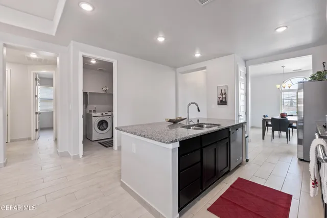 a kitchen with stainless steel appliances granite countertop a stove and a sink