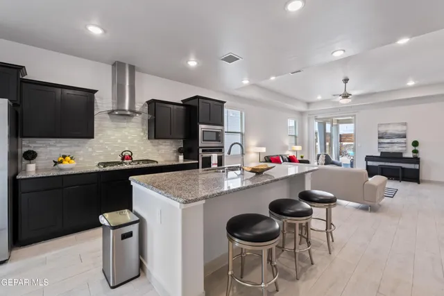 a kitchen with a dining table and chairs