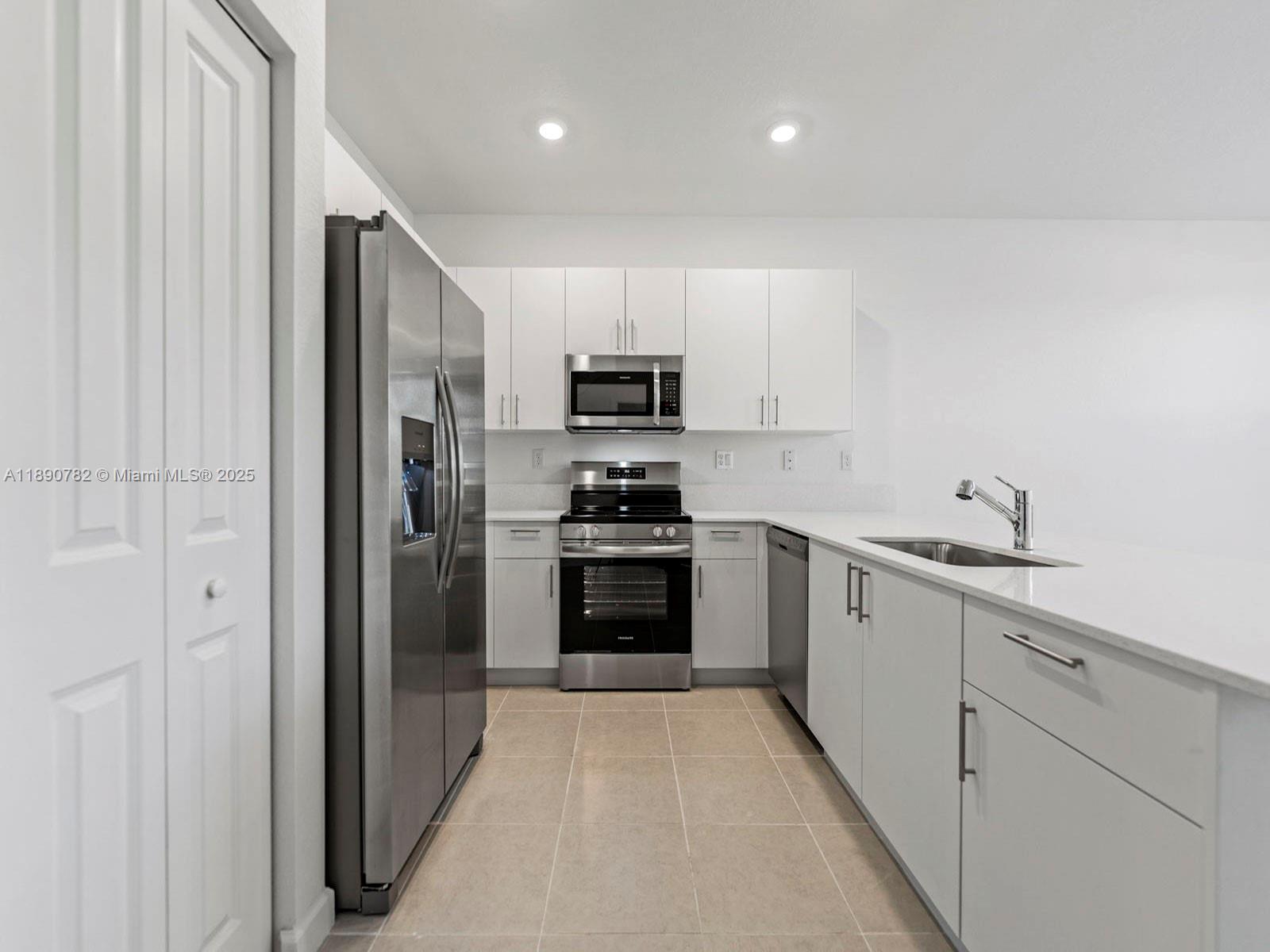 1533 Southeast 27th Street Homestead, FL 33035 - Photo 3 of 7 a kitchen with cabinets stainless steel appliances and a window