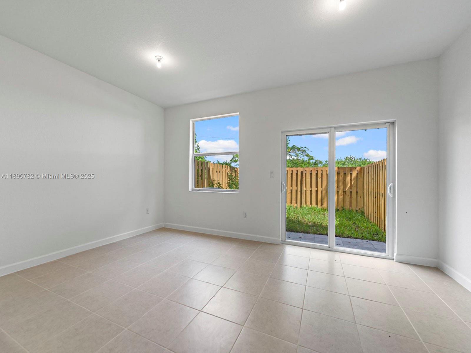 1533 Southeast 27th Street Homestead, FL 33035 - Photo 5 of 7 a view of an empty room with glass door