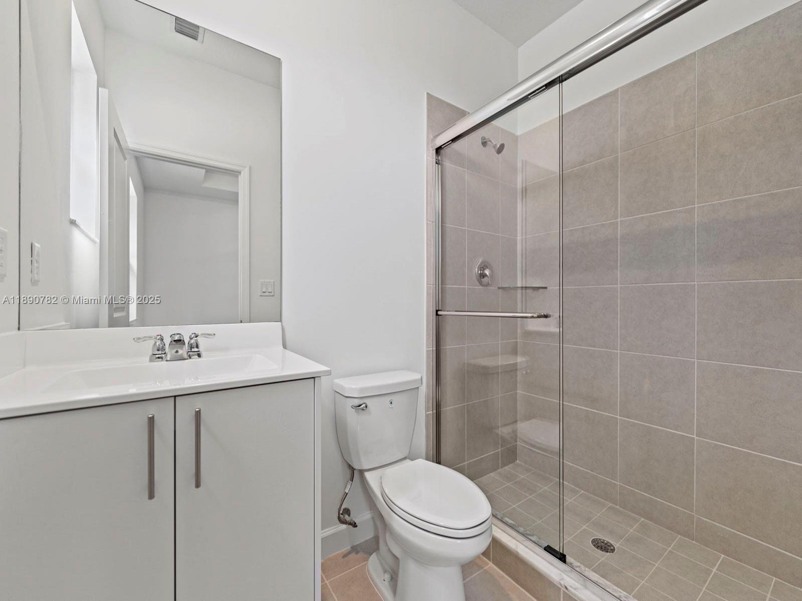 1533 Southeast 27th Street Homestead, FL 33035 - Photo 6 of 7 a bathroom with a shower a toilet sink and mirror