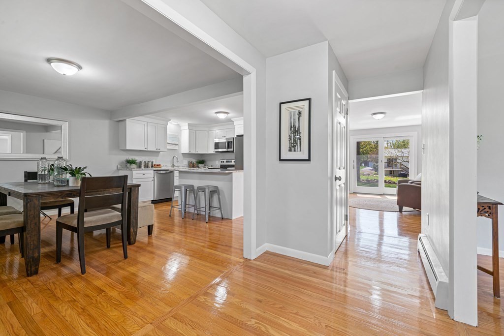 153 Goldthwaite Road Northbridge, MA 01588 - Photo 8 of 37 a view of a dining hall with stainless steel appliances a dining table wooden floor and a living room view