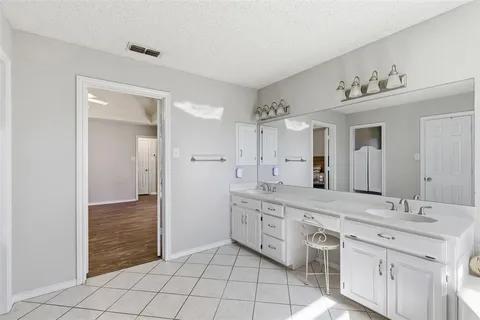 a spacious bathroom with a granite countertop sink a mirror and a