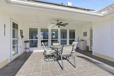 a view of a dining room with furniture and front door