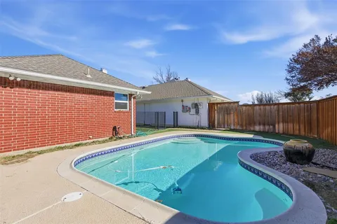 a view of a swimming pool with a backyard