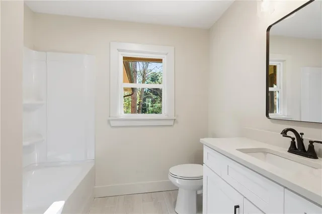a bathroom with a sink a toilet and a bathtub