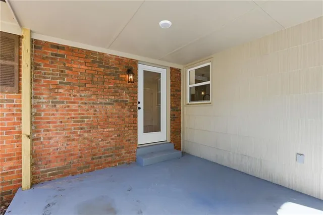 a view of an empty room with brick walls