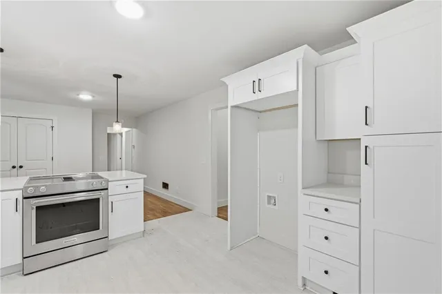 a kitchen with white cabinets and white appliances