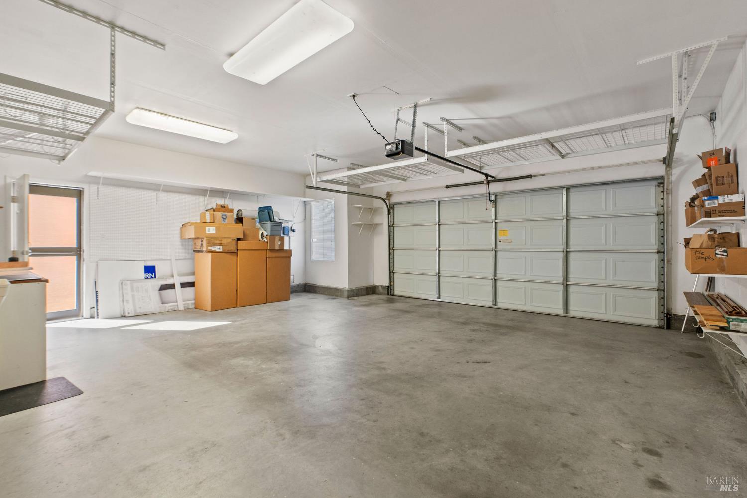 309 Southern Hills Drive Rio Vista, CA 94571 - Photo 32 of 73 expanded two-car garage with plenty of storage including handy ceiling racks; there is actually room for two cars and a golf cart!