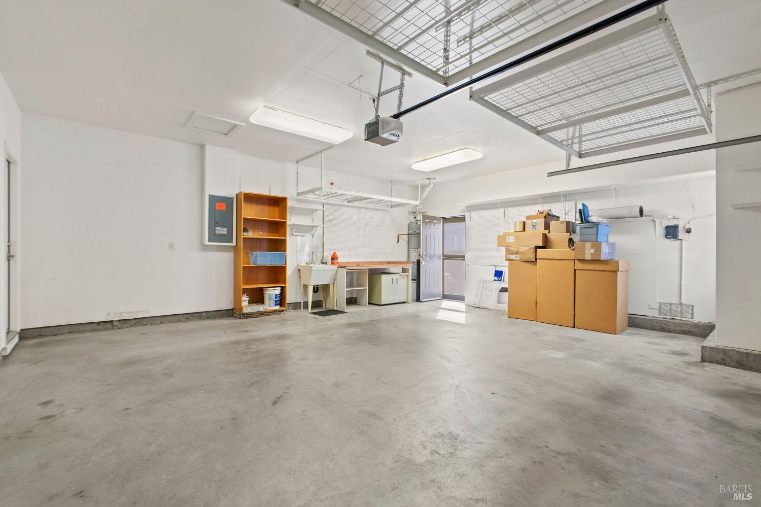 309 Southern Hills Drive Rio Vista, CA 94571 - Photo 33 of 73 garage with utility sink, ceiling storage racks, and a screen door!