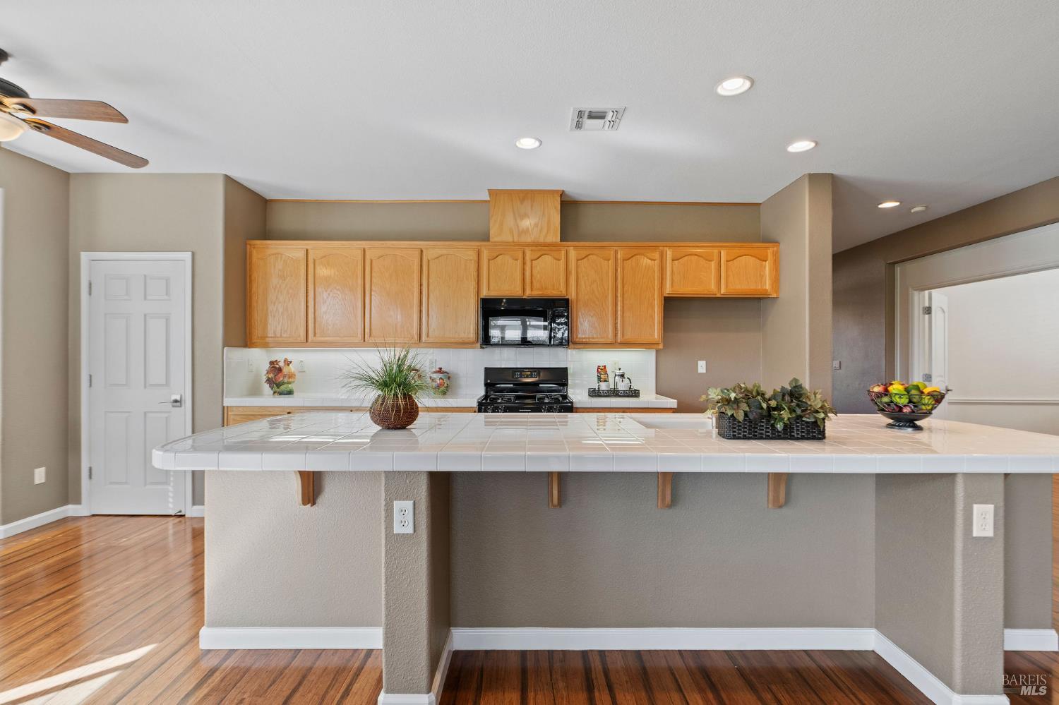 309 Southern Hills Drive Rio Vista, CA 94571 - Photo 7 of 73 a kitchen with kitchen island granite countertop a sink a counter space appliances and cabinets