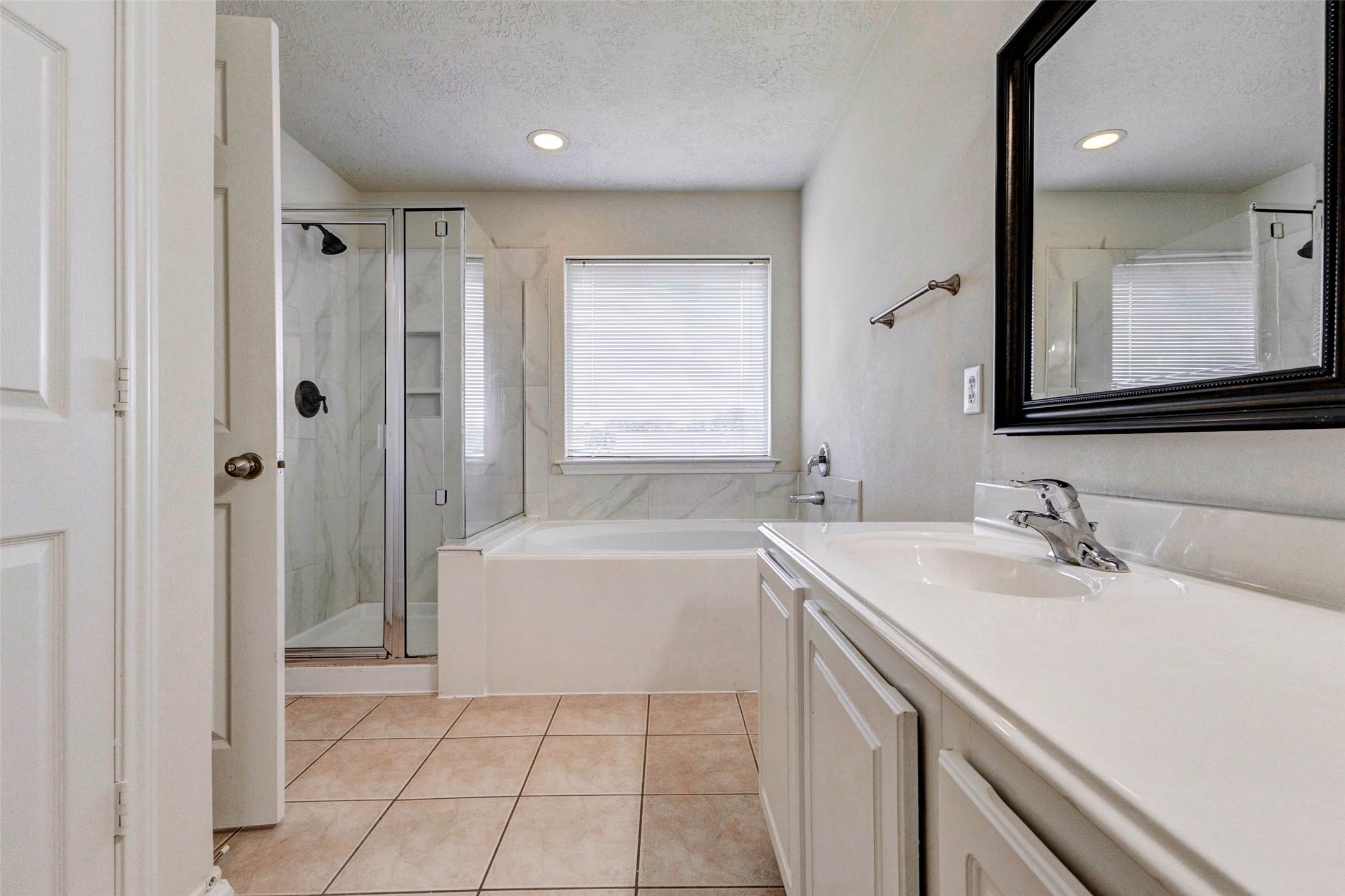 13106 Peppergate Lane Houston, TX 77044 - Photo 14 of 17 a bathroom with a sink a vanity and a mirror