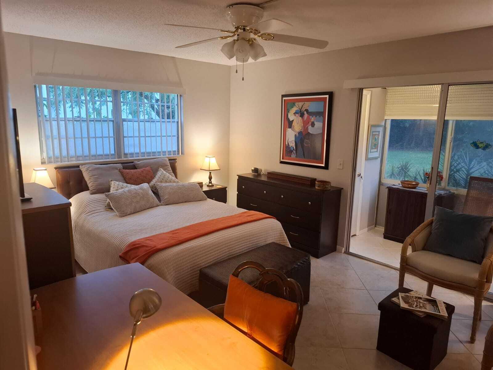 30 Oakridge C, Unit 30 Deerfield Beach, FL 33442 - Photo 11 of 12 a bedroom with furniture and a window